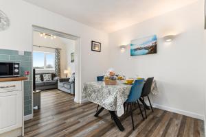 a kitchen and dining room with a table and chairs at Bramble Cottage - Dog Friendly Cottage Hot Tub in Begelly +17 photos