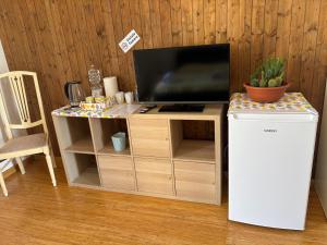 a entertainment center with a television on top of it at affittacamere Sestri Levante in Sestri Levante