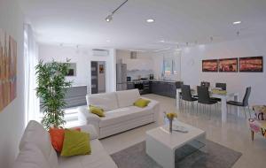 a living room with a white couch and a table at Villa Dobranka in Barban