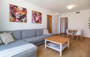 a living room with a couch and a table at Stunning Apartment In Torremolinos in Torremolinos