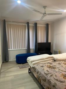 a bedroom with two beds and a flat screen tv at 76 Companion Crescent in Higgins
