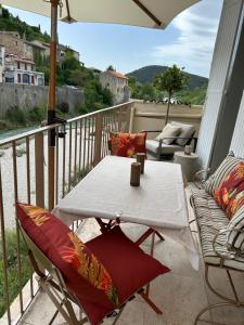 a white table and chairs on a balcony at Apartment Pont Romain in Vaison-la-Romaine