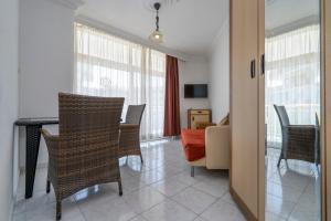 a living room with a table and chairs and a couch at Kleopatra Carmen Apart Hotel in Alanya