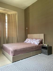 a bedroom with a bed and a night stand at Laman Bangau Temerloh in Temerloh