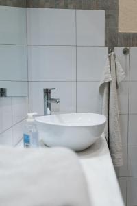 a white sink sitting on a counter in a bathroom at Traditional Stone House - Where Tradition Meets Comfort in Mesa Chorio +26 photos