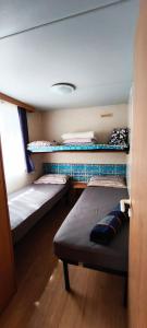 A bed or beds in a room at MareBlue Mobilhomes on Camping Mare e Pineta
