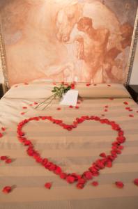 a bed with a heart made out of roses at Albergo Sant'Emidio in Ascoli Piceno