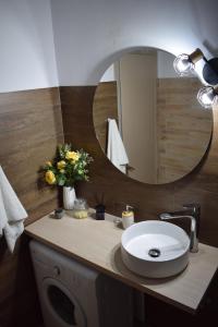 a bathroom with a sink and a mirror at S K apartments K in Argostoli +13 photos
