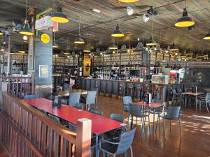 a restaurant with tables and chairs and a bar at Penthouse Las Terrazas de la Torre in Roldán