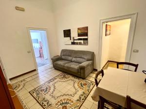 a living room with a couch and a table at Trapani Centro Mare in Trapani +13 photos