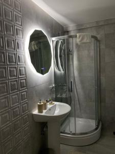 a bathroom with a sink and a shower at Astera 4 in Vrnjci +4 photos