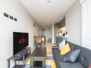 a living room with a couch and a tv at Amazing Views in Central Leeds - Pass The Keys in Leeds