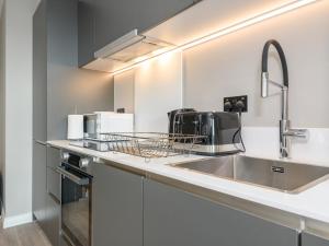 a kitchen with a sink and a microwave at Amazing Views in Central Leeds - Pass The Keys in Leeds