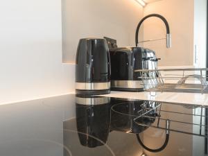two coffeemakers sitting on a counter in a kitchen at Amazing Views in Central Leeds - Pass The Keys in Leeds