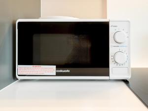 a microwave oven sitting on top of a counter at Amazing Views in Central Leeds - Pass The Keys in Leeds