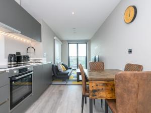 a kitchen and dining room with a table and chairs at Amazing Views in Central Leeds - Pass The Keys in Leeds