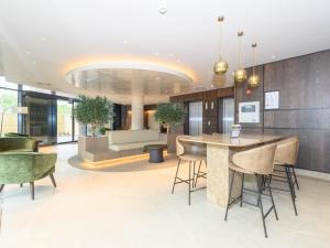 a lobby with a bar and chairs in a building at Amazing Views in Central Leeds - Pass The Keys in Leeds