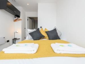 a bedroom with a bed with two towels on it at Amazing Views in Central Leeds - Pass The Keys in Leeds
