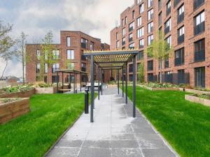 a walkway in front of a building with green grass at Amazing Views in Central Leeds - Pass The Keys in Leeds