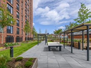 a patio with a picnic table and a building at Amazing Views in Central Leeds - Pass The Keys in Leeds