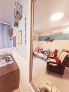 a mirror in a living room with a couch at תכלת המדבר in Mitzpe Ramon