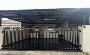a building with a gate in front of a building at J&Y Homestay Kluang in Kluang