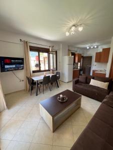a living room with a couch and a table at Penelope's Maisonette in Skala Potamias