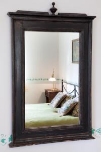 a mirror reflecting a bed in a bedroom at Villa Irbe in Jūrmala