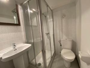 a bathroom with a shower and a toilet and a sink at CH El Quijote in Cala Murada