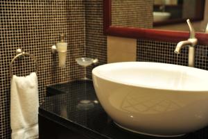 a bathroom with a white sink on a black counter at Crowne Plaza Al Khobar by IHG in Al Khobar