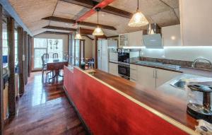 a kitchen with a long counter in a room at Stunning Apartment In Åsljunga in Åsljunga +12 photos