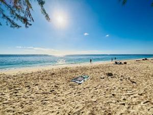 a beach with a kite laying on the sand at Modern and Luxury 3 bedroom apartment Steps from the beach in Flic-en-Flac