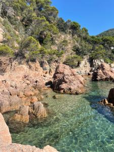 a body of water with rocks and water at Maison de village avec piscine à 10 min de la plage Costa Brava in Sant Feliu de Guixols