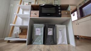 a kitchen with two bags on a shelf with a microwave at Domček na samote in Nové Mesto nad Váhom