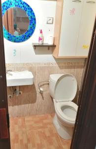 a bathroom with a toilet and a sink and a mirror at Roses in Roses +9 photos