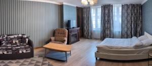 a bedroom with a bed and a chair and a table at Appartement à côté de port in Vendôme