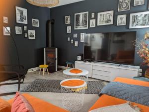 a living room with a large flat screen tv at La petite Ganette in Meymac