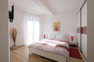 a white bedroom with a bed and a window at Villa Dobranka in Barban +25 photos