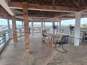 a patio with a table and chairs on a balcony at COD Haven Ventures Apartments in Madina