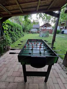 a ping pong table sitting on a patio at Műemlék parasztház in Szentbékkálla