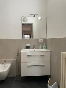 a white bathroom with a sink and a mirror at Casa Silvia in Morbegno +21 photos