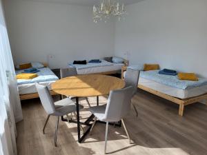Zimmer mit 4 Betten, Tisch und Stühlen in der Unterkunft Emily Apartments, moderne ruhige Wohnung, nur 4 km von der A2 in Leopoldshöhe
