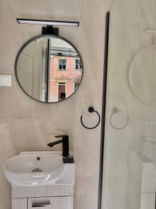 a bathroom with a sink and a mirror at Lumière Carmela in Corfu +13 photos