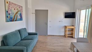 a living room with a blue couch and a television at רגעים בגולן in Keshet