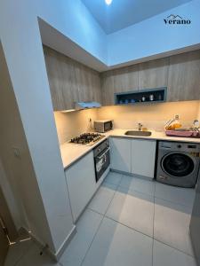 a small kitchen with a stove and a sink at Chalet at Marassi, Marina West in El Alamein
