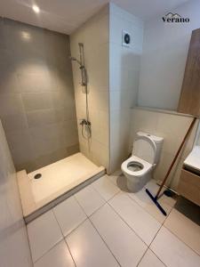 a small bathroom with a toilet and a shower at Chalet at Marassi, Marina West in El Alamein