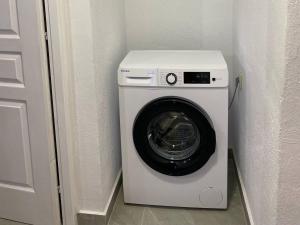 a washing machine in a corner of a room at Patriko Stone House in Fourka