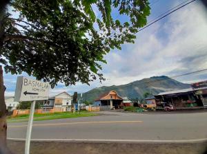 a sign on the side of a street in a town at Basmalah Homestay in Sembalun Lawang