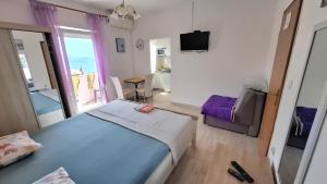 a bedroom with a bed and a view of the ocean at Guesthouse Martina in Senj