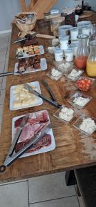 a wooden table with plates of food on it at La Maison des Poulains in Sauzon